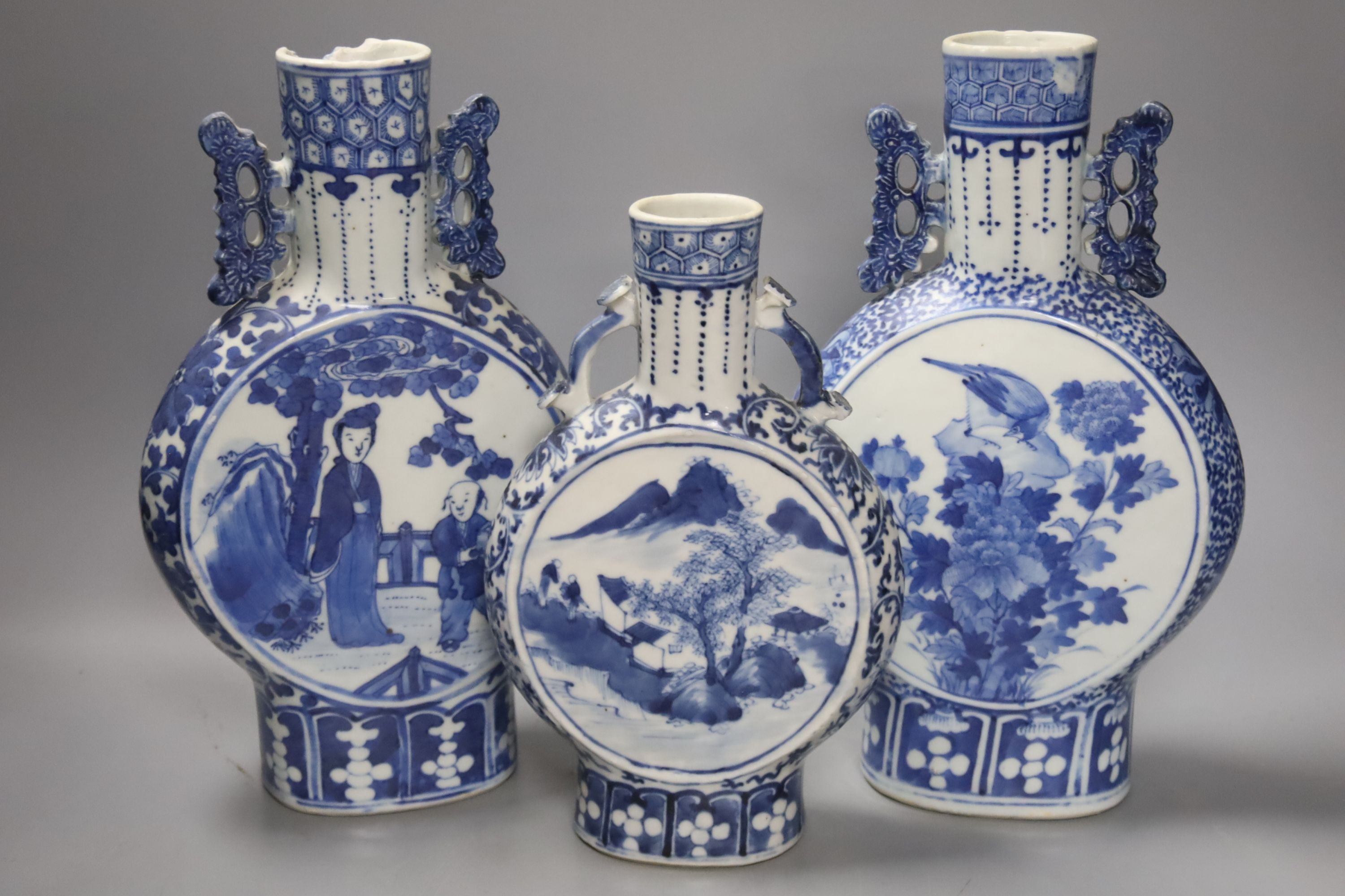 Three 19th century Chinese blue and white Moon flasks, tallest 31 cms.